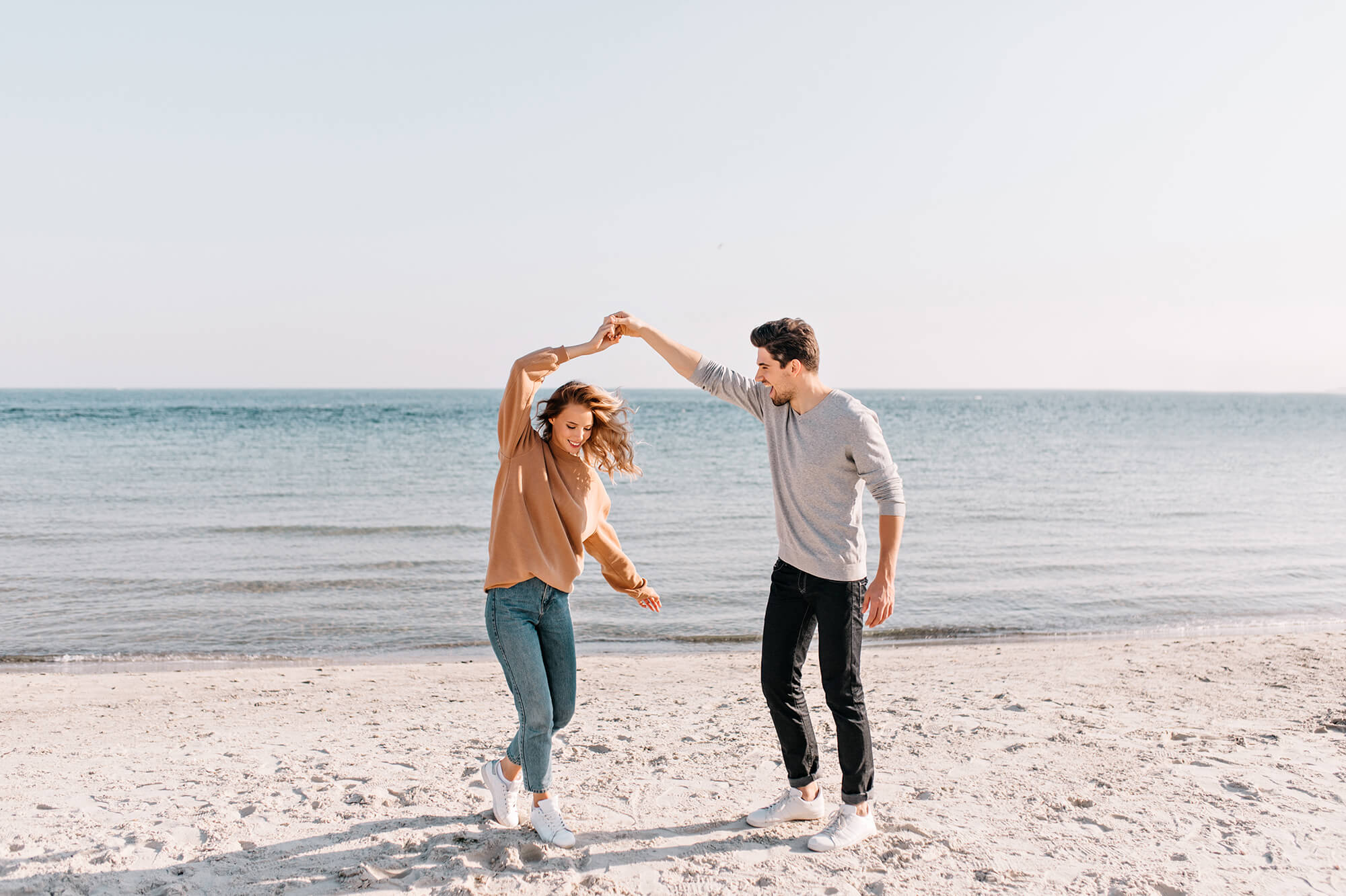 Young couple dancing on the beach.